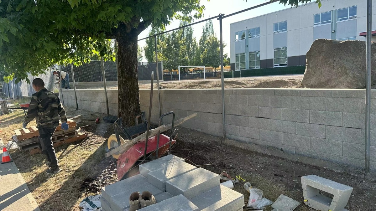 Concrete block retaining wall construction in progress