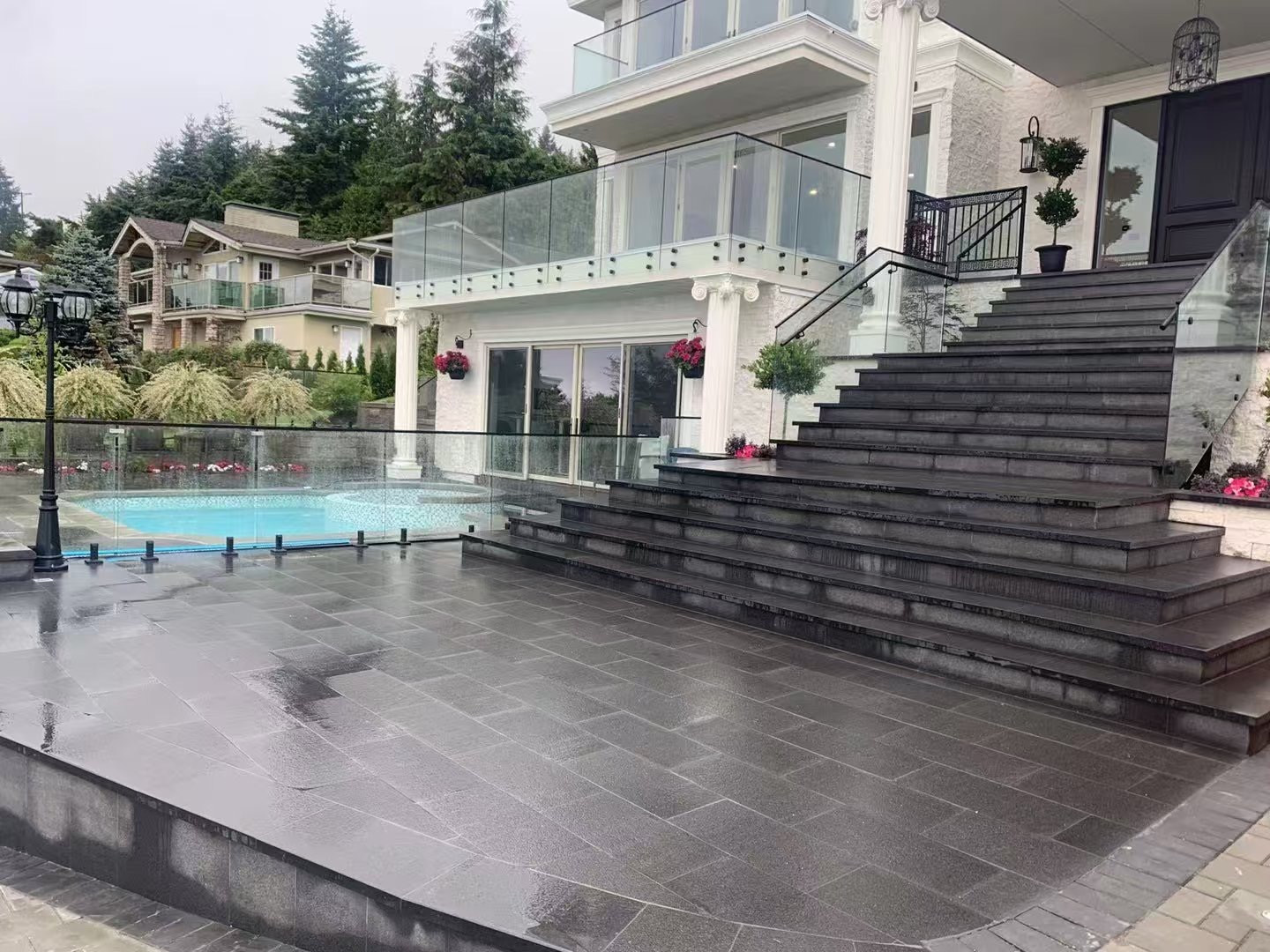 Luxury home with granite patio, pool, and grand staircase
