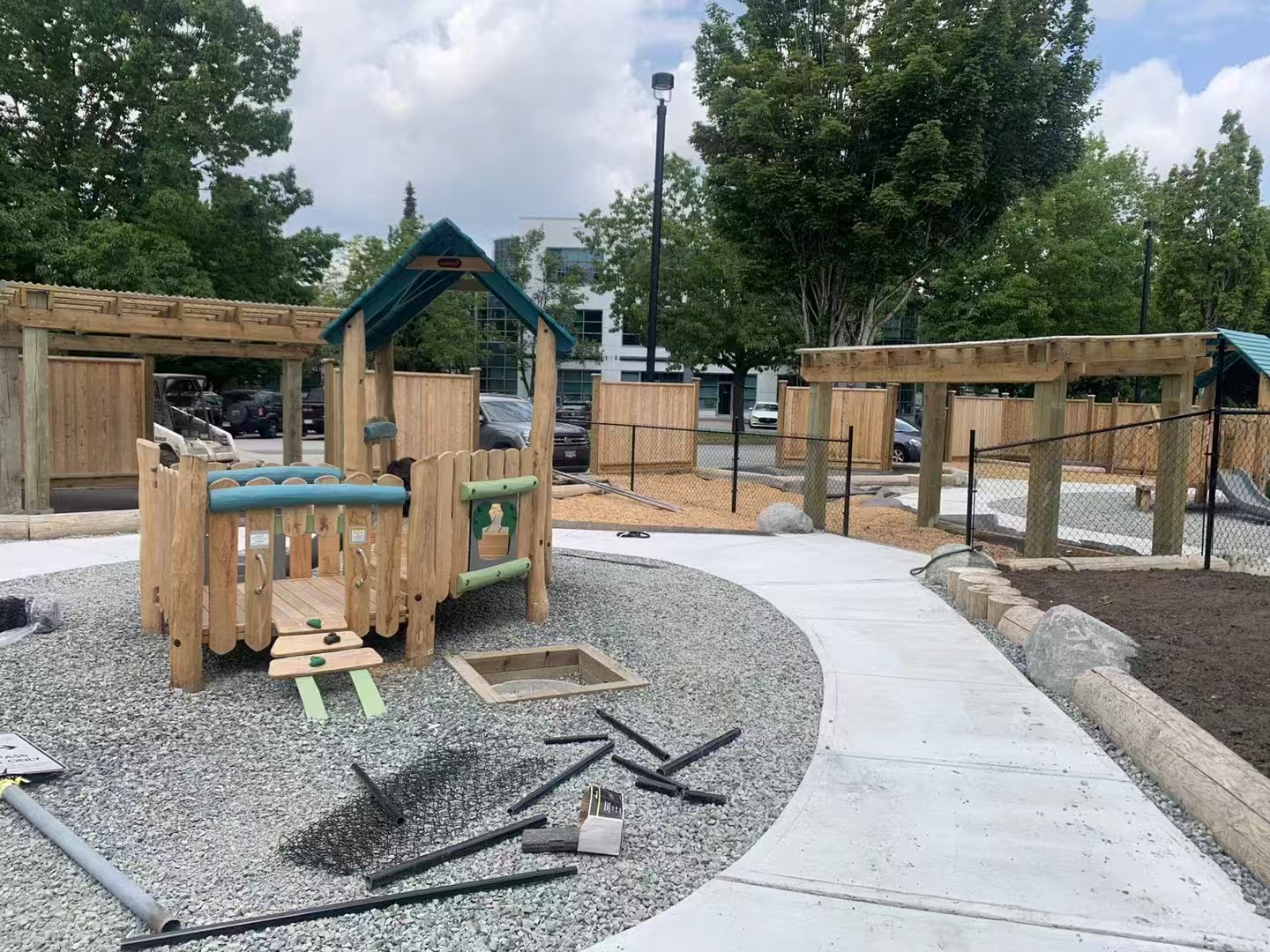 Commercial playground installation with wooden play structure