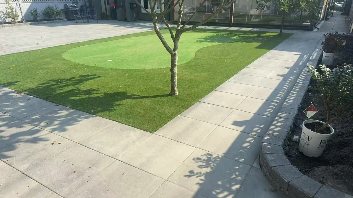 Putting green with artificial turf around tree