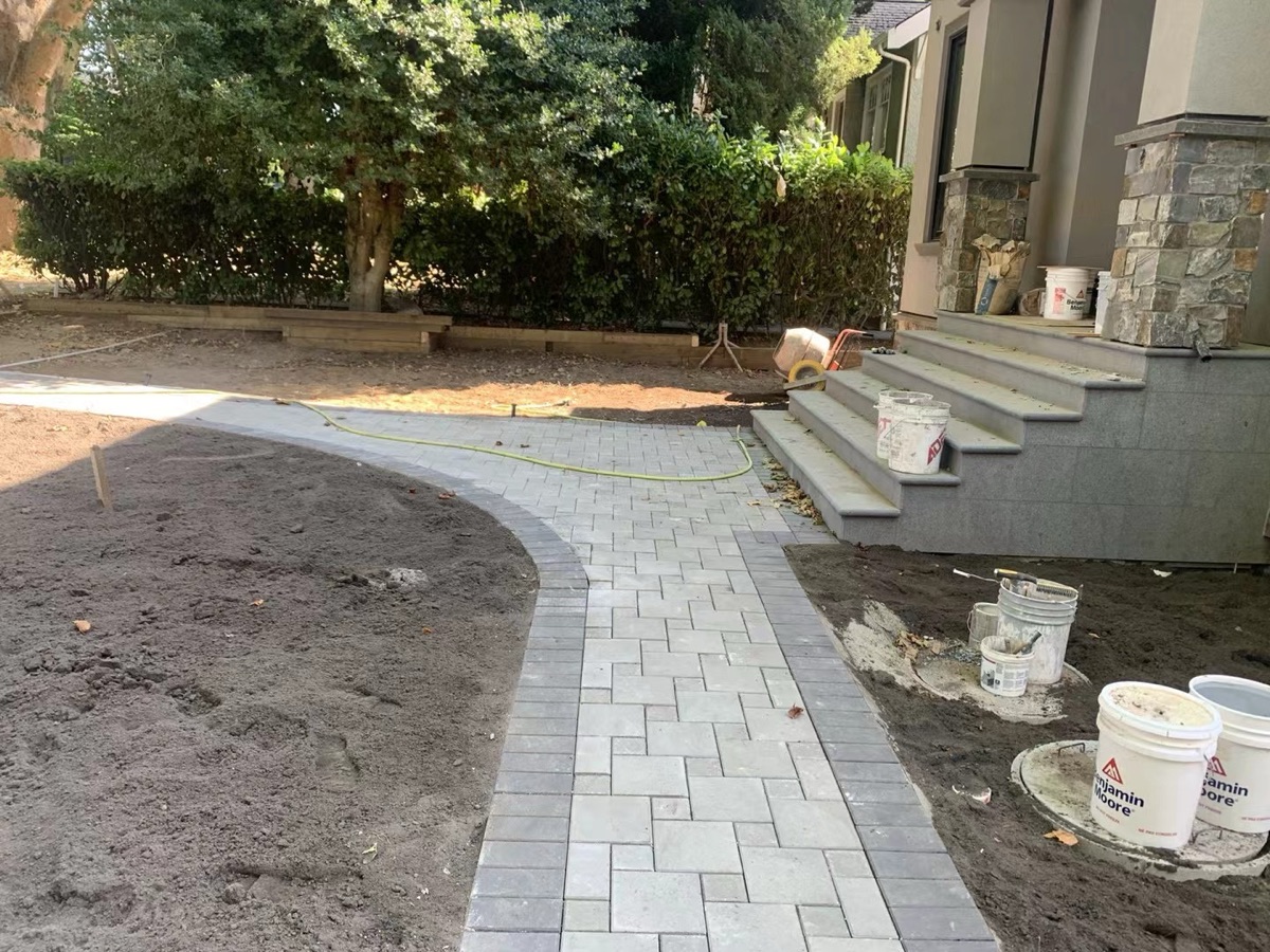 Paver walkway with steps leading to entrance